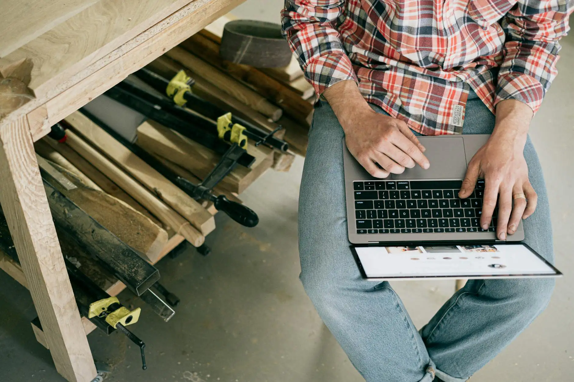 A small business owner working on a laptop surrounded by AI tool icons