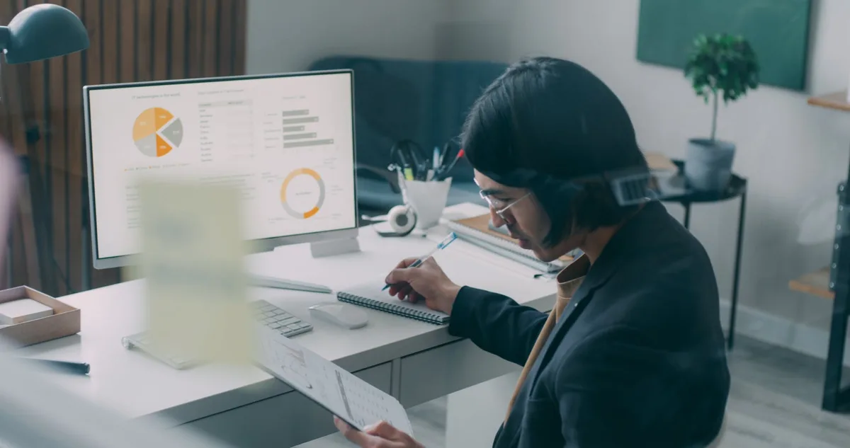 A business professional reviewing AI analytics dashboards in a modern office