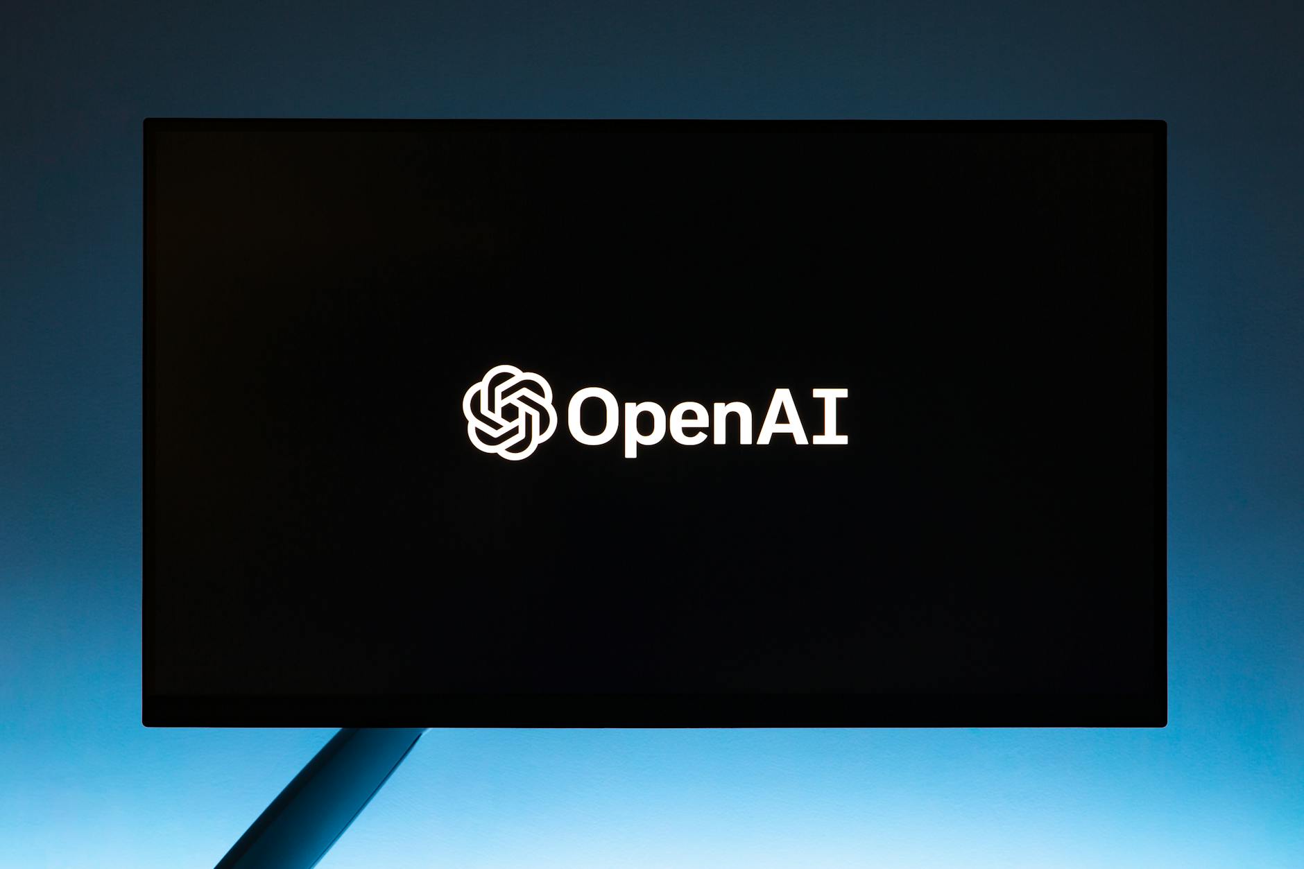 OpenAI logo and Astral logo side by side against a dark code-themed background representing the acquisition